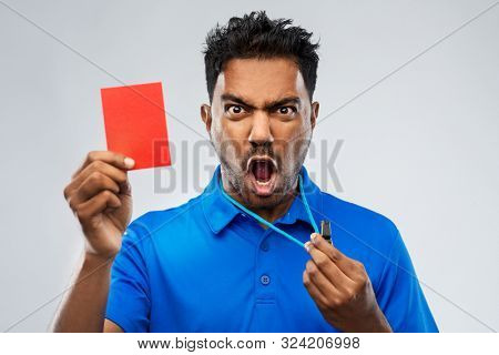 sport, caution, game and football concept - angry indian male referee with whistle and showing red penalty card