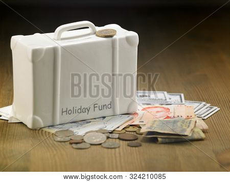 lugagge shape saving jar on the wooden table