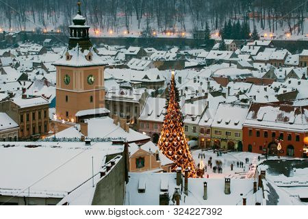 Brasov, Romania - January 13, 2019: Night image of the old town and City Hall square of Brasov.Panoramic view of the Brasov old city in Transylvania,Romania.