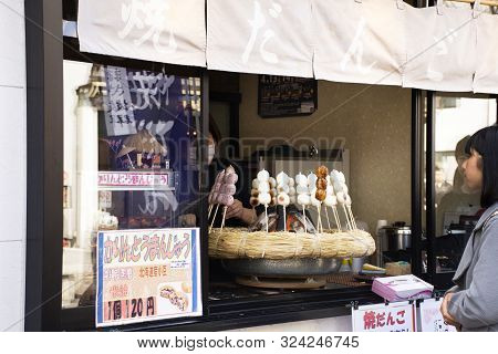Japanese People And Foreign Traveler Stand Waiting Line Up For Buy Dango Or Japanese Dumpling And Sw