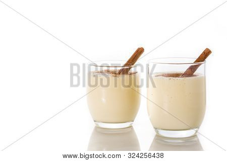 Homemade Eggnog With Cinnamon In Glass Isolated On White Background. Typical Christmas Dessert.copy 