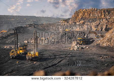 Open Coal Mine. Drilling Machine Borer Installing Cast Explosives Blasting
