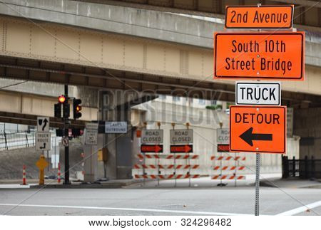 Traffic Detour Signs In Downtown Rush Hour With Traffic Light Road Closure