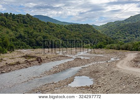 Mountain Stonebed Of River At The Cloudy Summer Day