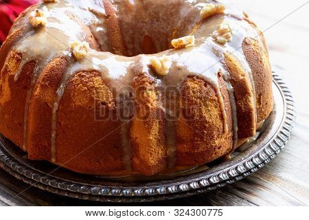 Delicious, Pumpkin Spice Bundt Cake Frosted With Brown Sugar Glaze And Walnuts Oven A Rustic Wood Ta