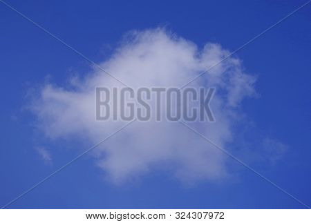 White Round Cloud On A Background Of Blue Sky.