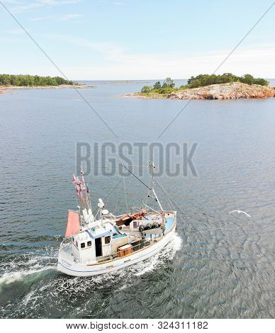 Grisslehamn, Sweden - Jul 03, 2019: Small Fishingboat On The Sea On The Way To Put The Fishing Nets 