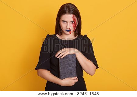 Close Up Portrait Of Woman With Horror Halloween Make Up And Bloody Wound Posing In Studio Against Y