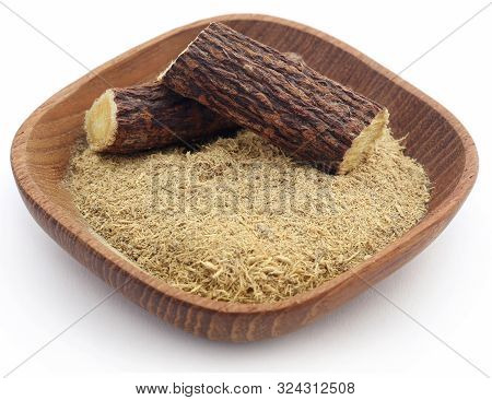 Liquorice With Powder In A Bowl Over White