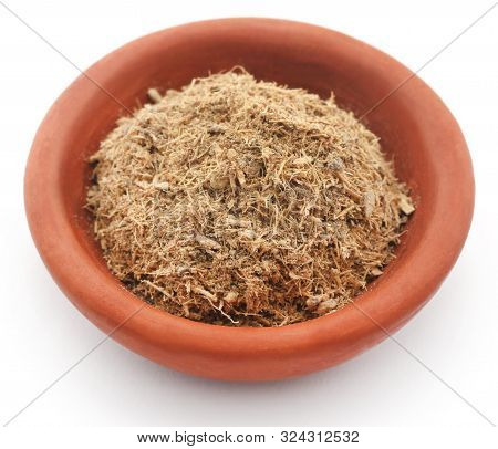 Liquorice In A Bowl Over White Background