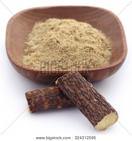 Liquorice Stick And Ground In A Bowl Over White
