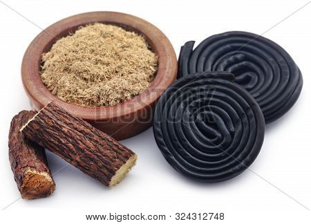 Liquorice Powdere With Candy Over White Background
