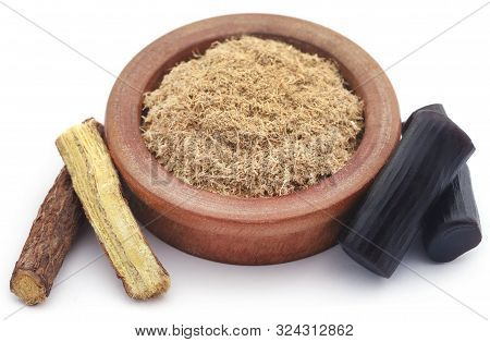 Liquorice Powder In A Bowl And Candy Over White Background