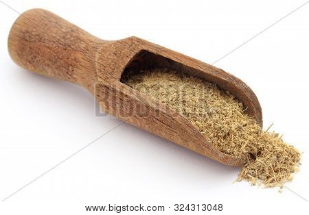 Liquorice Ground In A Wooden Scoop Over White Ackground
