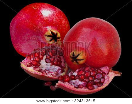 Red Ripe Pomegranate Fruit On A Black Background.