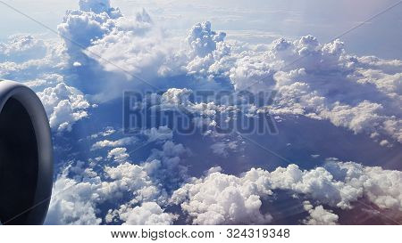 Panorama From Air Liner Porthole To Thick Clouds Of Blue Sky Of Airplane