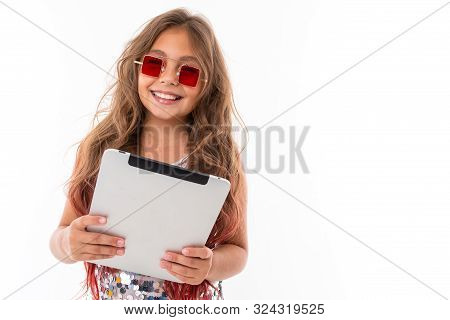 Beautiful Girl In Square Red Sunglasses Holding Light Grey Tablet Screen Against White Background Is