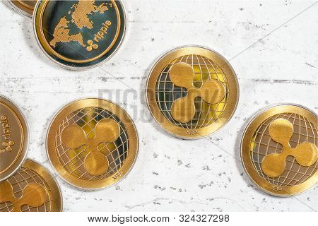 Detail On Xrp Ripple Cryptocurrency Golden Coins On White Stone Like Board, Photographed From Above