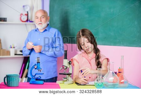 Little Girl With Man Tutor Study Science. Pedagogue Career. Experienced Pedagogue. Expand Your Mind.