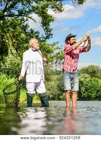 Perfect Weekend. Successful Catch. Elegant Bearded Man And Brutal Hipster Fishing. Hobby And Recreat