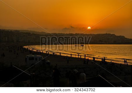 tangier cornice orange sunset  on the beach with buildings, Panoramic View of Tangier Harbor Mediter