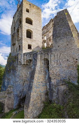 Scenic Ruins Of Ancient Castle  Likava On Rock On Blue Cloudy Sky Background. Liptov Region. Slovaki