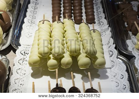 Fruits Bananas, Strawberries, Nuts, Apples, Peaches Drenched In White And Dark Chocolate.