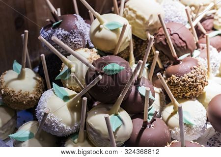 Fruits Bananas, Strawberries, Nuts, Apples, Peaches Drenched In White And Dark Chocolate.