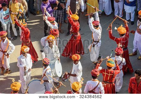 Jaisalmer, India - February 17, 2019: Ceremonial Procession Indian Men Dancing In Traditional Clothi