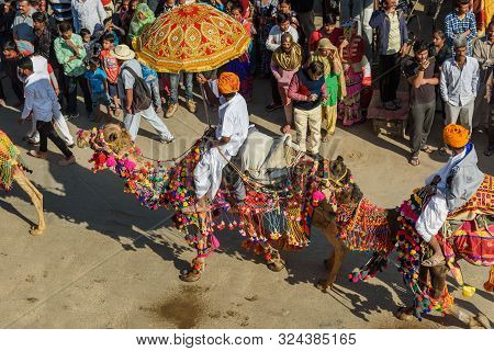 Jaisalmer, India - February 17, 2019: Ceremonial Procession Camels And Riders In Desert Festival In 