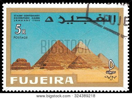 Fujeira - Circa 1966: A Stamp Printed In Fujeira Shows  Pyramids At Giza With Inscription And Name O