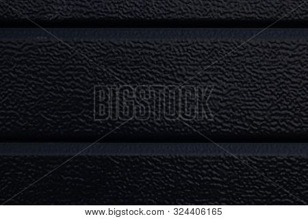 Close-up Of Black Rough Siding Surface Defocused
