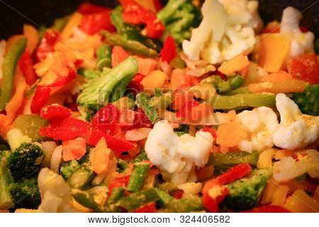 Frozen Vegetables, Including Pepper Broccoli And Cauliflower Being Cooked