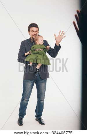 Family Portrait On White Background. A Man Lifted A Girl Up. The Trust Business Partners