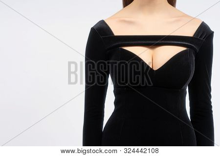 Young Female Breast In The Sexy Black Velvet Dress. Beautiful Shapes And Collarbones With Dress Neck
