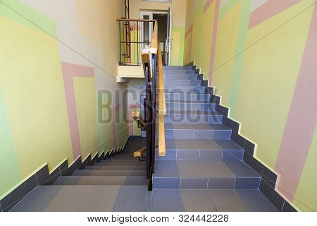 Wide Staicase Covered With Ceramic Tiles Indoors In A House Interior.