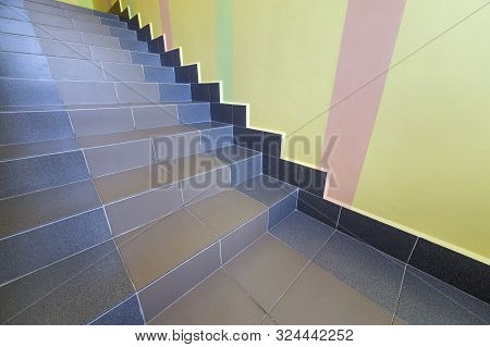 Wide Staicase Covered With Ceramic Tiles Indoors In A House Interior.