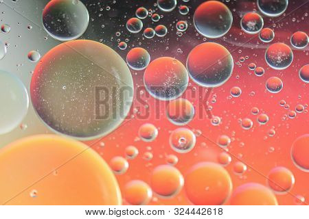 Oil Drops In Water. Defocused Abstract Psychedelic Pattern Image Red And Orange Colored. Abstract Ba