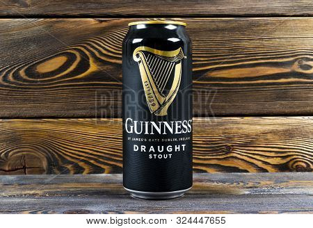 Helsinki, Finland, September 25, 2019: Aluminium Can Of Guinness Draught Stout Beer Bottle On Dark W