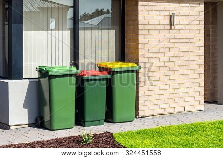 Australian Waste Wheelie Bins With Colourful Lids For Recycling, Green And General Waste Provided By