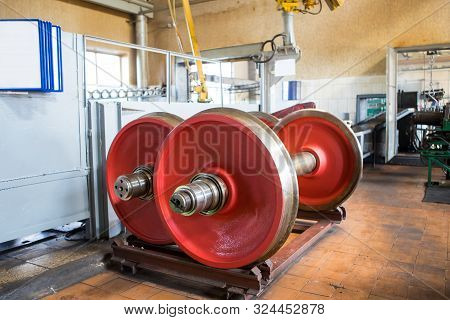 Railway Wheelsets Of Red Color In The Repair Shop.