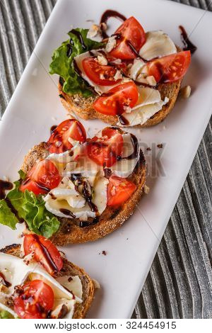 Bruschetta With Tomatoes, Lettuce, Camambert, Balsamic Vinegar