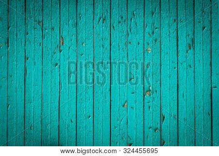 Old Bright Green Wooden Fence With Peeled Off Paint Texture Background