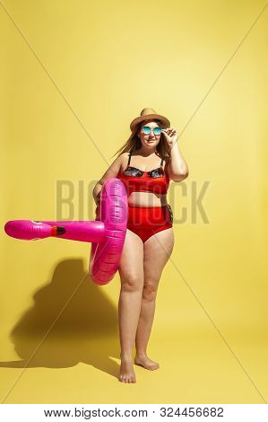 Young Caucasian Plus Size Female Models Preparing For Beach Resort On Yellow Background. Woman In Re