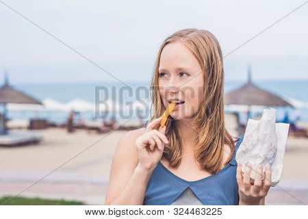 Women Eat Fried Sweet Potatoes In The Park. Junk Food Concept