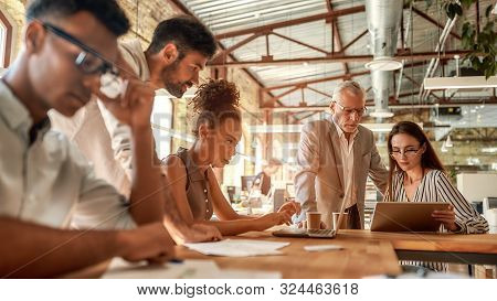 Busy Day. Group Of Business People Working Together And Communicating In The Modern Office