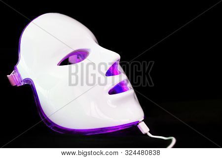 Light Rejuvenating Mask For Facial Skin Therapy On Black Background