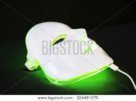 Light Rejuvenating Mask For Facial Skin Therapy On Black Background