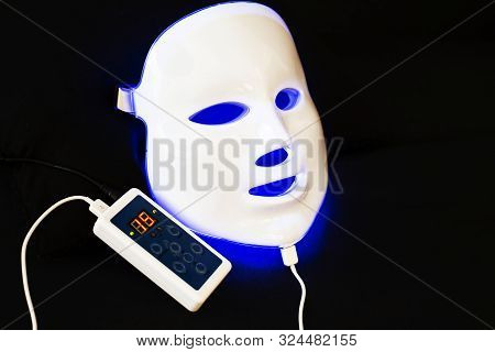 Light Rejuvenating Mask For Facial Skin Therapy On Black Background