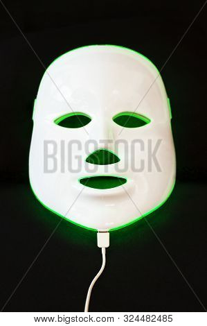 Light Rejuvenating Mask For Facial Skin Therapy On Black Background